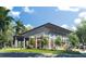 Exterior view of the community center with outdoor seating, modern architecture, and landscaping at 11685 Great Brook Ln, Parrish, FL 34219