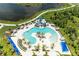 Overhead shot of a resort-style community pool with a slide, seating, and blue sunshades at 11685 Great Brook Ln, Parrish, FL 34219
