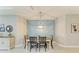 Dining room with modern light fixture and decorative wall accent, complemented by neutral paint tones and tile floors at 11685 Great Brook Ln, Parrish, FL 34219