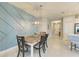 Dining room featuring an accent wall, modern lighting and a view of the entryway at 11685 Great Brook Ln, Parrish, FL 34219