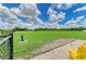 Well-maintained dog park with a fenced area, lush grass, and a comfortable seating area at 11685 Great Brook Ln, Parrish, FL 34219