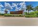 Community entrance sign amidst lush landscaping and clear blue skies at 11685 Great Brook Ln, Parrish, FL 34219