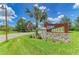 Community entrance sign with lush greenery and clear blue skies at 11685 Great Brook Ln, Parrish, FL 34219