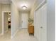 Bright entryway with tile flooring, a stylish console table with a mirror, and a view into the bedroom at 11685 Great Brook Ln, Parrish, FL 34219