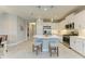 Spacious kitchen with a large island, white cabinetry, stainless steel appliances, and modern pendant lighting fixtures at 11685 Great Brook Ln, Parrish, FL 34219