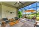 Relaxing screened lanai with outdoor seating, a ceiling fan, a grill, and tranquil views of the outdoors at 11685 Great Brook Ln, Parrish, FL 34219
