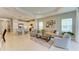 Open-concept living area featuring modern furnishings, a kitchen island, and lots of natural light at 11685 Great Brook Ln, Parrish, FL 34219