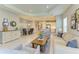 Spacious living area featuring an open floor plan, stylish decor, and access to the kitchen and dining room at 11685 Great Brook Ln, Parrish, FL 34219