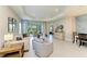 Bright living room featuring neutral tones, modern decor, and a sliding glass door leading to the outdoor patio at 11685 Great Brook Ln, Parrish, FL 34219