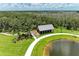 Aerial view of an outdoor pavilion with a pond and walking path at 11685 Great Brook Ln, Parrish, FL 34219