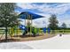 Community playground with slides and climbing structures under a blue sunshade at 11685 Great Brook Ln, Parrish, FL 34219