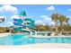 Resort-style pool area featuring water slides, lounge chairs, and sunny relaxation spaces at 11685 Great Brook Ln, Parrish, FL 34219