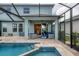 Outdoor area features a pool, spa, covered patio, and views of the lush backyard and pool at 12564 Night View Dr, Sarasota, FL 34238