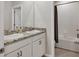 Bathroom featuring double vanity with granite counters and a shower-tub combination at 12564 Night View Dr, Sarasota, FL 34238