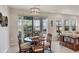Bright dining area features a stylish light fixture, and sliding glass doors to the screened-in lanai at 12564 Night View Dr, Sarasota, FL 34238