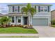Charming two-story home boasts a well-manicured lawn, beautiful landscaping, and a two-car garage at 12564 Night View Dr, Sarasota, FL 34238