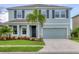 Charming two-story home with a well-maintained lawn, beautiful landscaping, and a two-car garage at 12564 Night View Dr, Sarasota, FL 34238