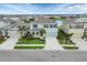 A charming two-story home with a well-manicured lawn, a driveway, and lush landscaping at 12564 Night View Dr, Sarasota, FL 34238