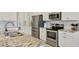 Gorgeous kitchen with granite countertops, stainless steel appliances, and white cabinetry at 12564 Night View Dr, Sarasota, FL 34238