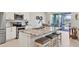 Modern kitchen features stainless steel appliances, granite countertops and an island with barstool seating at 12564 Night View Dr, Sarasota, FL 34238