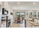 Open concept kitchen with stainless appliances and granite counters opens to the dining area with lake views at 12564 Night View Dr, Sarasota, FL 34238