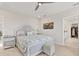 Bright main bedroom with light gray decor, a soft bed, and an en-suite bathroom at 12564 Night View Dr, Sarasota, FL 34238