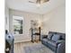 Cozy home office with a comfortable leather sofa, standing desk, and a view of the screened pool at 12564 Night View Dr, Sarasota, FL 34238