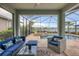 Relax on the screened-in patio with outdoor seating and views of the pool, spa, and lake at 12564 Night View Dr, Sarasota, FL 34238