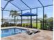 Outdoor pool area features a spa, sun loungers, and a lovely view of the lake and landscaping at 12564 Night View Dr, Sarasota, FL 34238