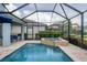 Beautiful outdoor screened pool and patio area with lounge furniture and landscaping at 12564 Night View Dr, Sarasota, FL 34238