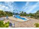 Community splash pad features a slide, sprinklers, and lounge seating on a brick patio at 12564 Night View Dr, Sarasota, FL 34238