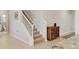Elegant staircase with neutral carpet and white banister leads to the upper level of this home at 12564 Night View Dr, Sarasota, FL 34238
