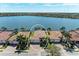 Waterfront home in Nokomis, Florida, featuring lush landscaping and scenic water views on a sunny day at 138 Toscavilla Blvd, Nokomis, FL 34275