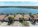 Scenic waterfront home in Nokomis, Florida, boasts mature palm trees and stunning water views on a sunny day at 138 Toscavilla Blvd, Nokomis, FL 34275