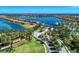 Breathtaking aerial view of a luxurious waterfront community with stunning architecture, lush landscaping, and a serene lake at 138 Toscavilla Blvd, Nokomis, FL 34275