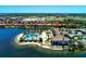 Breathtaking aerial view of the community pool, clubhouse, and surrounding waterfront homes at 138 Toscavilla Blvd, Nokomis, FL 34275
