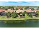 Scenic waterfront home in Nokomis, Florida, with mature landscaping and gorgeous water views on a sunny day at 138 Toscavilla Blvd, Nokomis, FL 34275