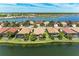 Scenic waterfront home in Nokomis, Florida, featuring mature palm trees and picturesque water views on a sunny day at 138 Toscavilla Blvd, Nokomis, FL 34275