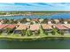 Beautiful waterfront home in Nokomis, Florida, with lush landscaping and panoramic water views on a clear day at 138 Toscavilla Blvd, Nokomis, FL 34275