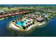 A beautiful aerial view of the community pool, clubhouse, and scenic waterfront homes at 138 Toscavilla Blvd, Nokomis, FL 34275