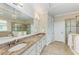 Spacious bathroom features double sinks, granite countertops, soaking tub, and a separate glass shower at 138 Toscavilla Blvd, Nokomis, FL 34275