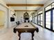 Billiards room with a pool table, bar area, and access to an outdoor patio overlooking the water at 138 Toscavilla Blvd, Nokomis, FL 34275