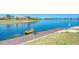 Wooden dock with a kayak in the water, providing access to the serene lake at 138 Toscavilla Blvd, Nokomis, FL 34275