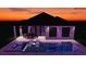 A modern home exterior featuring a backyard pool, outdoor dining, and sleek architectural lines at 138 Toscavilla Blvd, Nokomis, FL 34275