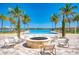 Community fire pit by the pool, perfect for socializing with neighbors, and waterfront views at 138 Toscavilla Blvd, Nokomis, FL 34275