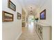 Elegant foyer featuring tile floors, tray ceiling, artwork, and cabinet at 138 Toscavilla Blvd, Nokomis, FL 34275