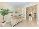 Bright home office with tile floors, a large desk, and an open doorway to the living room at 138 Toscavilla Blvd, Nokomis, FL 34275