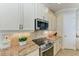 Close-up of the kitchen featuring granite countertops and stainless steel appliances at 138 Toscavilla Blvd, Nokomis, FL 34275