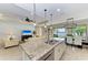Open concept kitchen with island, pendant lighting and views of the waterfront at 138 Toscavilla Blvd, Nokomis, FL 34275