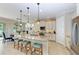 Bright kitchen featuring granite countertops, stainless steel appliances, and barstool seating at 138 Toscavilla Blvd, Nokomis, FL 34275